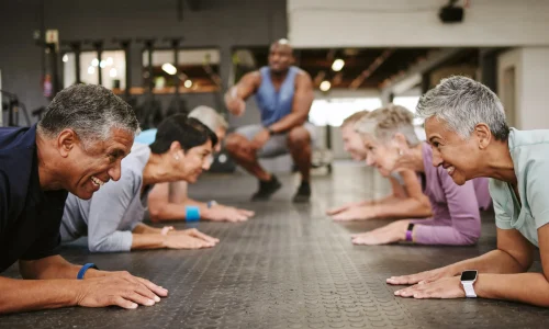 senior-people-fitness-plank-with-personal-trainer-class-workout-core-exercise-training-gym-elderly-group-coaching-ab-session-strong-abdominal-muscles-gymnasium-floor